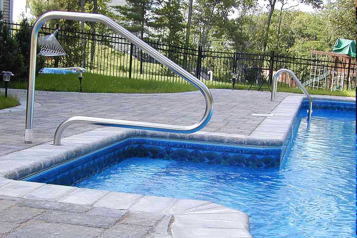 The Natural Landscape Inc. – Concrete paver pool coping and deck